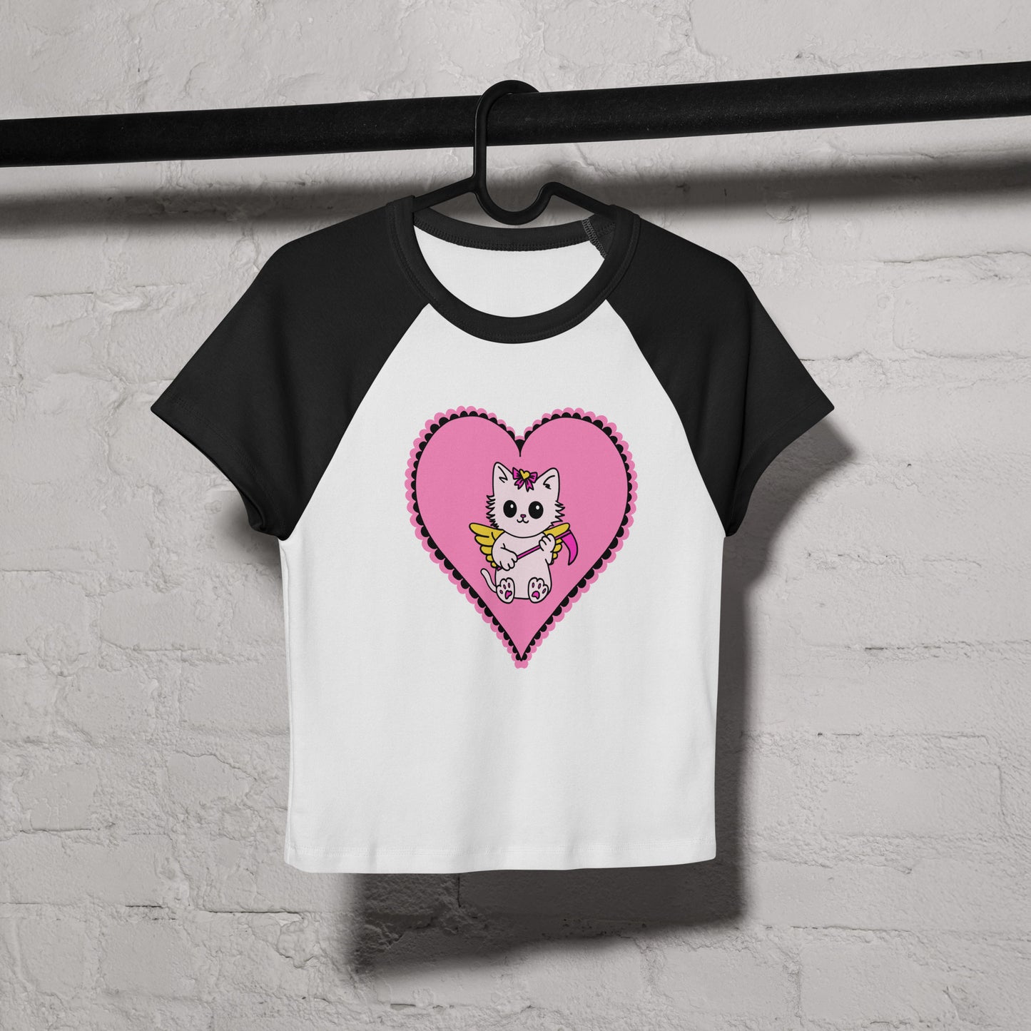 Black and white baseball shirt with a pink heart and cartoon cat design on a white background