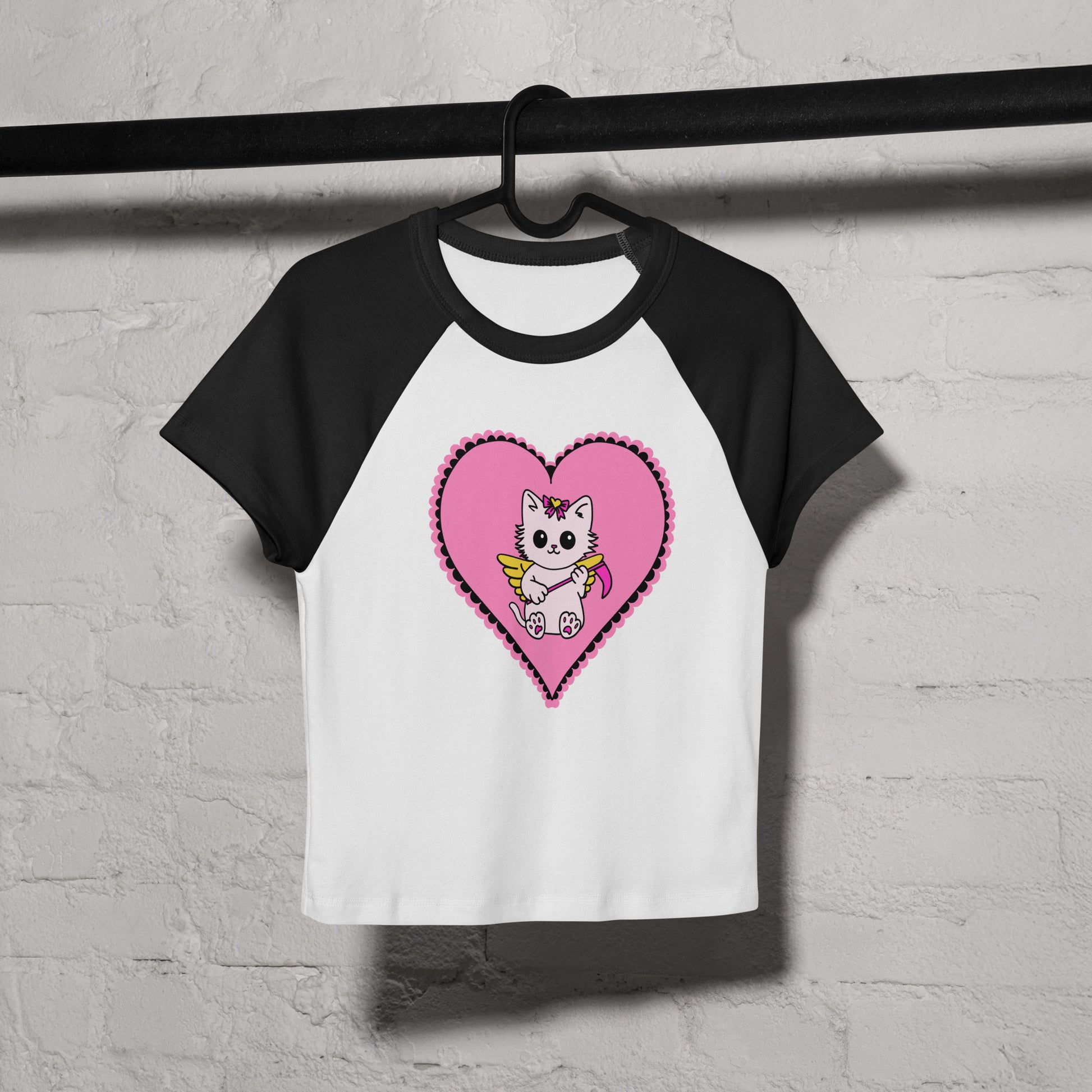 Black and white baseball shirt with a pink heart and cartoon cat design on a white background